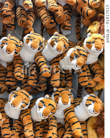 tiger dolls hang on to the wall for sales in kid depart at departmentstore. 91817015