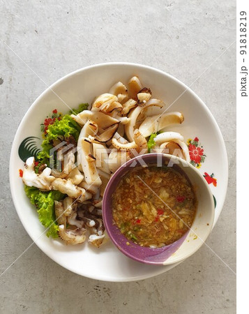 Grilled squid or octopus at Thai seafood market Grilled squid or octopus at Thai seafood market 91818219