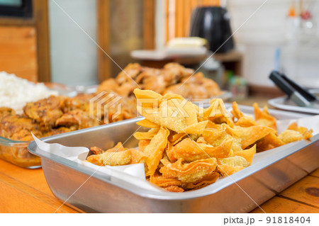 a lot of homemade Thai deep fried wonton in aluminum plate prepare for Asia noodle style. 91818404