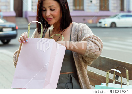 Young beautiful woman smiling going to the shops with eco bags Young beautiful woman smiling going to the shops with eco bags 91821984