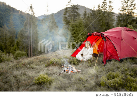 Young woman enjoys nature while travel in the mountains 91828635