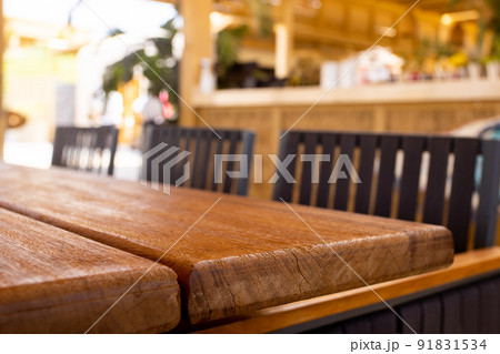 Table empty background in cafe ,restaurant background.Front view. . Dining table. Brochure background.Bar outside in summer vacation Table empty background in cafe ,restaurant background.Front view. . Dining table. Brochure background.Bar outside in summer vacation 91831534