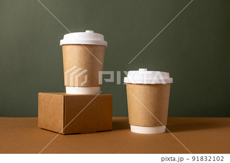 Coffee craft paper cups with place for logo on green and brown background, natural color, for menu and restaurants  91832102