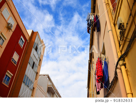 Clothes after washing are hanging to dry on the background of the facade of the house. 91832633