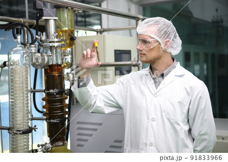 scientist  analyzing a biological and ecological hemp plant used for herbal pharmaceutical CBD oil and THC oil in a laboratory. 91833966