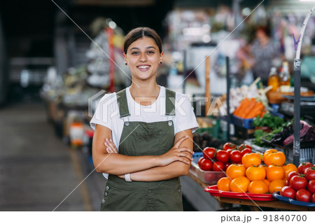 Woman seller at the counter with vegetables. Small business concept Woman seller at the counter with vegetables. Small business concept 91840700