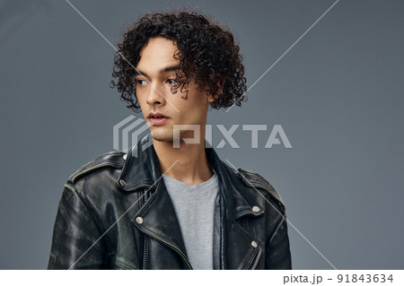 Pensive handsome stylish tanned curly man...の写真素材 [91843634 ...
