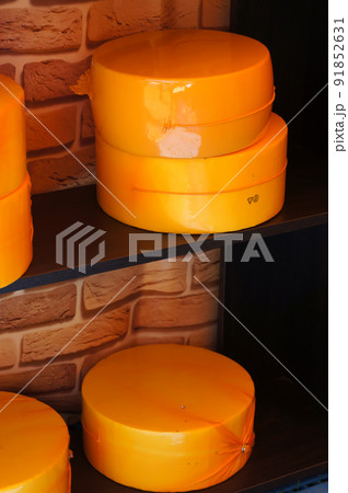 Cheese Heads on Shelves at the Food Market. Whole cheese wheels. Cheese Heads on Shelves at the Food Market. Whole cheese wheels. 91852631