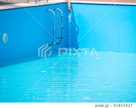 Pouring fresh water into swimming pool. Clear blue water refreshing disinfection purification, algae bacteria prevent. 91853937