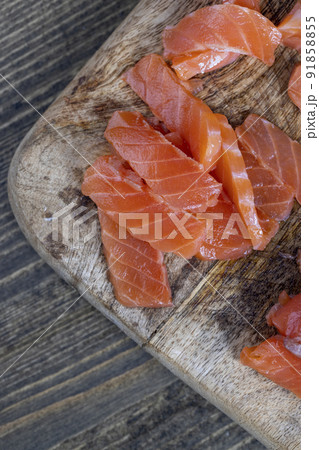 cutting fish fillets during the preparation of a dish of red salmon fish 91858855