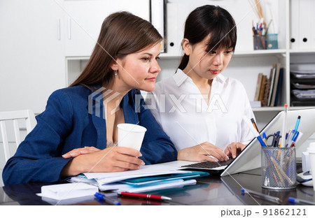 Two businesswomen working with computer in office Two businesswomen working with computer in office 91862121