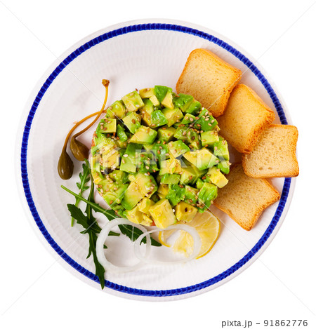 Salmon tartare with avocado and croutons 91862776