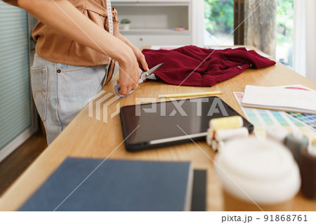 Fashion design concept, Asian female fashion designer is tailoring clothes for the new collection 91868761