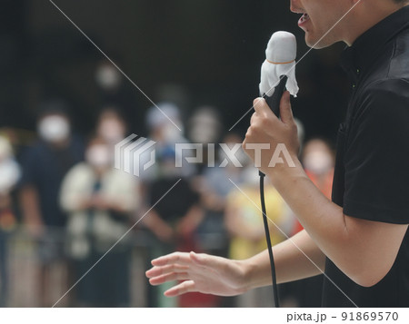 駅前で街頭演説する人とコロナ渦のためマスクをしている聴衆 駅前で街頭演説する人とコロナ渦のためマスクをしている聴衆 91869570
