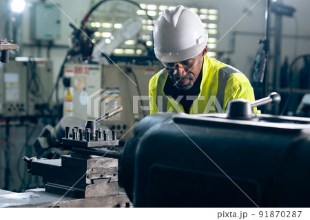 Factory worker or engineer do machine job in adept manufacturing workshop 91870287