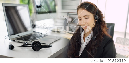 Business people wearing headset working in office broaden view Business people wearing headset working in office broaden view 91870559