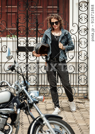 Woman Walking to Her Motorcycle 91871868