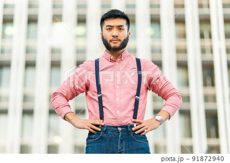 Serious asian man in casual clothes looking at the camera Serious asian man in casual clothes looking at the camera 91872940