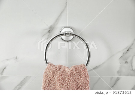 Holder with clean towel on light wall Holder with clean towel on light wall 91873612