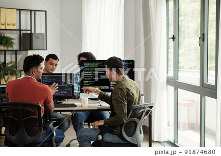 Developers Discussing Programming Code 91874680