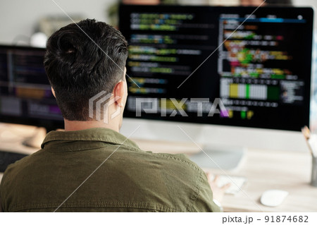 Software Developer Looking at Programming Code 91874682
