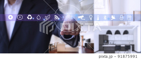 Man hand point smarth home GUI in livingroom. Hand use smart screen smart home automation assistant on a virtual screen and a user touching a button 91875991