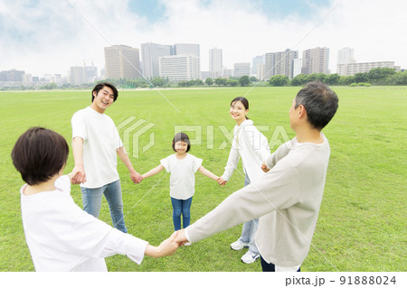 手を繋ぎ輪を作る三世代家族 91888024