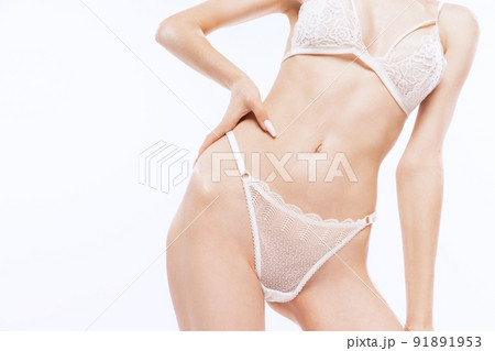 Cropped image of slender pale female body wearing white lingerie isolated over white background. Beauty, fashion, ad, art concept. 91891953