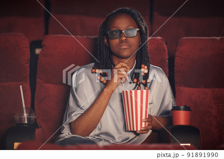 Woman watching 3d movie in cinema 91891990
