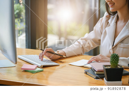 data analysis, budget calculation, research, risk management, Asian women using computers and financial documents in capital planning to increase company profits. 91892878