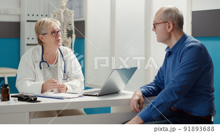 Senior doctor attending consultation with sick patient at appointment in medical office, examining diagnosis for recovery. Checkup visit to find prescription treatment, health care system. Senior doctor attending consultation with sick patient at appointment in medical office, examining diagnosis for recovery. Checkup visit to find prescription treatment, health care system. 91893688