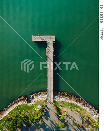 Top view of pier and sea with sunlight, aerial view Top view of pier and sea with sunlight, aerial view 91895441