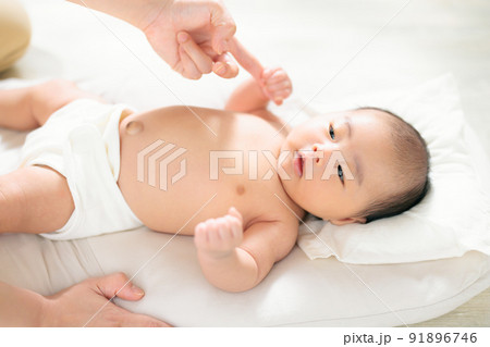 親子のふれあい　手遊び　ふれあい遊び　把握反射　ママの指を握る赤ちゃん　生後1ヶ月 91896746