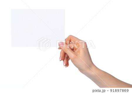 Woman's hand holding blank white sheet of paper isolated on white 91897869