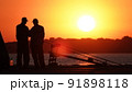 Silhouette of fishermen on the pier at sunset 91898118