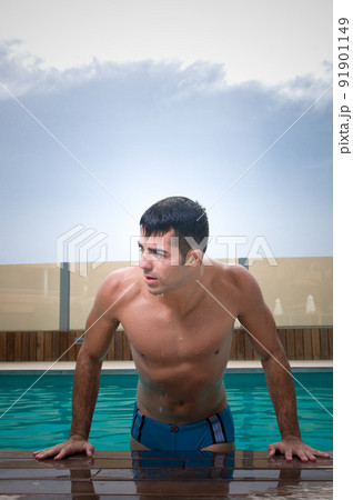 Sensual man in swimming pool Sensual man in swimming pool 91901149