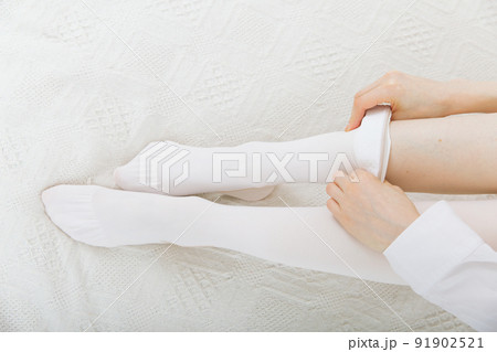 Anti-embolic Compression Hosiery for surgery isolated on white. Medical white stockings, tights for varicose veins and venouse therapy. Thrombo embolic deterrent hose or anti-embolism stockings. 91902521