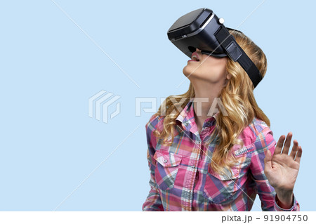 Young casual woman uses virtual glasses on color background. Young casual woman uses virtual glasses on color background. 91904750