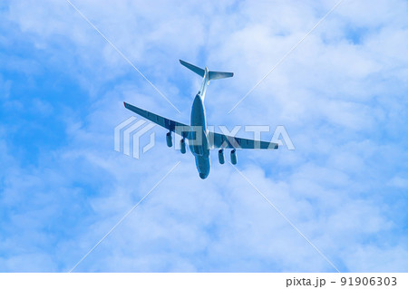 Airplane is flying in blue sky. Commercial passenger and cargo air transportation. Airplane is flying in blue sky. Commercial passenger and cargo air transportation. 91906303