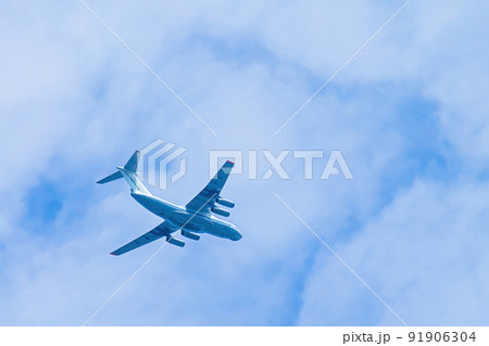 Airplane in blue sky. Air cargo transportation. Plane is flying in clouds. Airplane in blue sky. Air cargo transportation. Plane is flying in clouds. 91906304