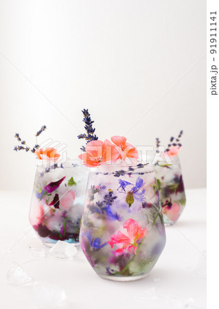 Cold drink with frozen flowers Cold drink with frozen flowers 91911141