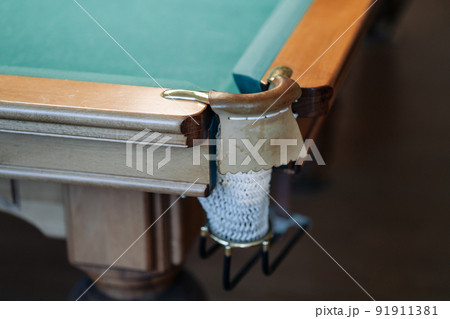 Billiard table with green surface and balls in the billiard club. 91911381