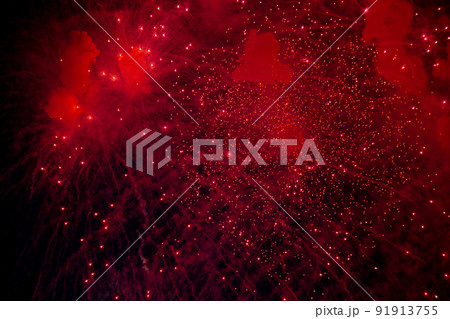 A bright firework with a red glowing center with red sparks and smoke flying towards the background of the night sky. High quality photo A bright firework with a red glowing center with red sparks and smoke flying towards the background of the night sky. High quality photo 91913755