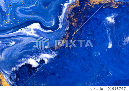 Luxury fluid art painting background. Spilled blue, white and gold acrylic paint. Liquid marble. Alcohol ink splash. Luxury fluid art painting background. Spilled blue, white and gold acrylic paint. Liquid marble. Alcohol ink splash. 91913767