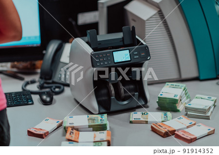Sorted banknotes placed on the table after it is counted on the electronic money counting machine Sorted banknotes placed on the table after it is counted on the electronic money counting machine 91914352