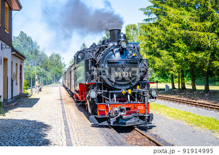 Old steam locomotive on narrow-gauge railwaytrack 91914995