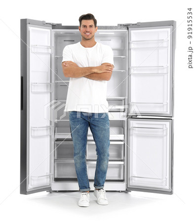 Man near open empty refrigerator on white background 91915534