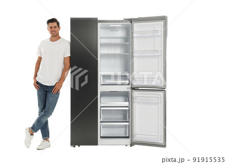 Man near open empty refrigerator on white background Man near open empty refrigerator on white background 91915535