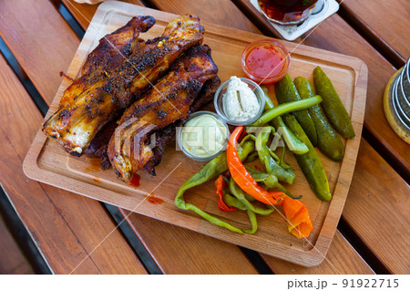 Grilled pork ribs with sauces, pickled vegetables 91922715