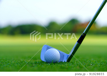Man Golfer Hitting Ball with Club on Beatuiful Golf Course 91928655
